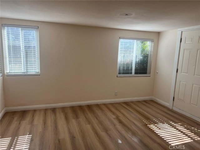 spare room with hardwood / wood-style floors