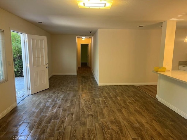 unfurnished room featuring dark wood-type flooring