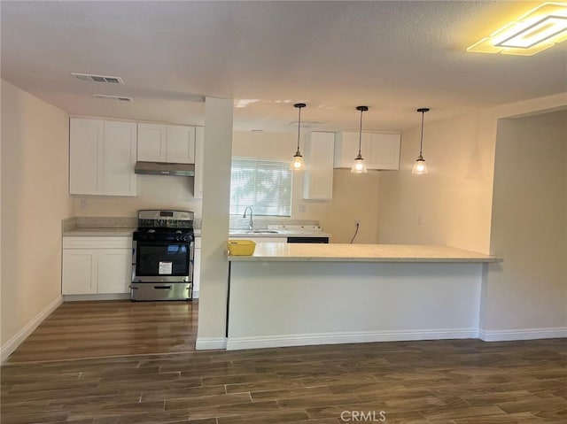 kitchen with stainless steel electric stove, kitchen peninsula, sink, and white cabinets