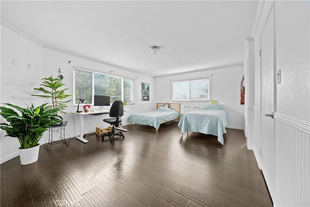 bedroom with crown molding and dark wood-type flooring