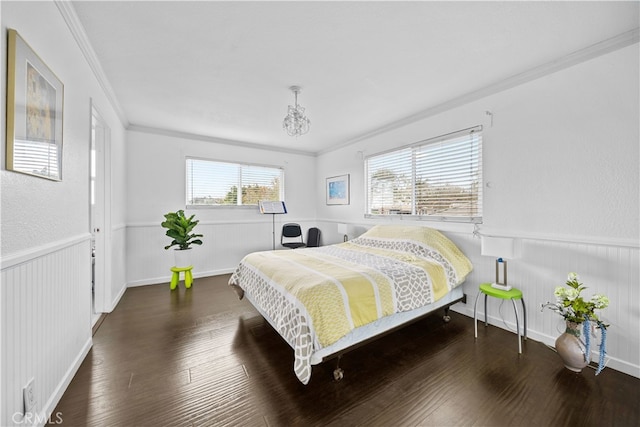 bedroom featuring multiple windows, ornamental molding, and dark wood-type flooring