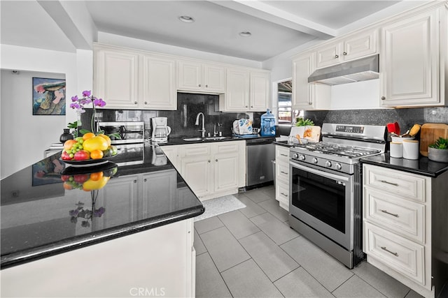 kitchen featuring sink, white cabinetry, stainless steel appliances, light tile patterned flooring, and decorative backsplash