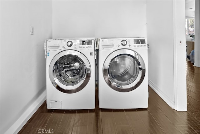 laundry area featuring washer and clothes dryer and dark hardwood / wood-style floors