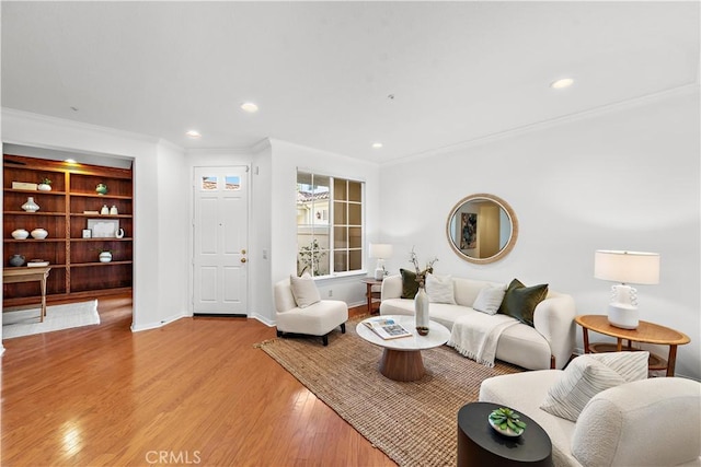 living room featuring light wood-type flooring and crown molding