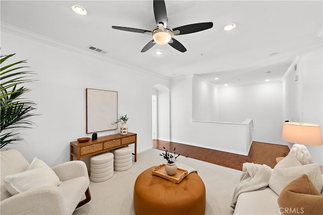 living room with crown molding, hardwood / wood-style floors, and ceiling fan