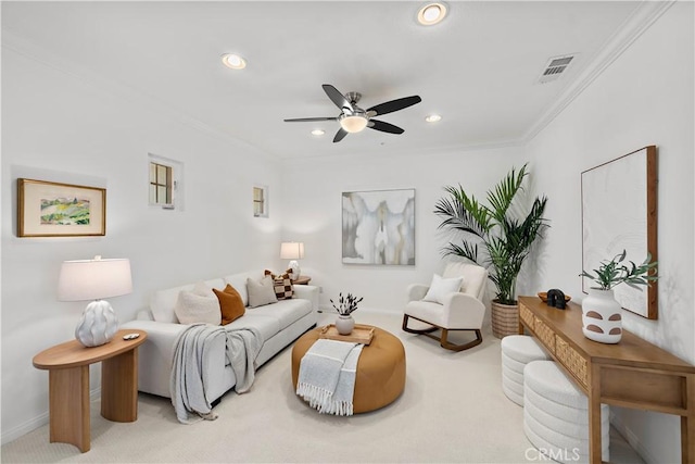 carpeted living room featuring ceiling fan and ornamental molding