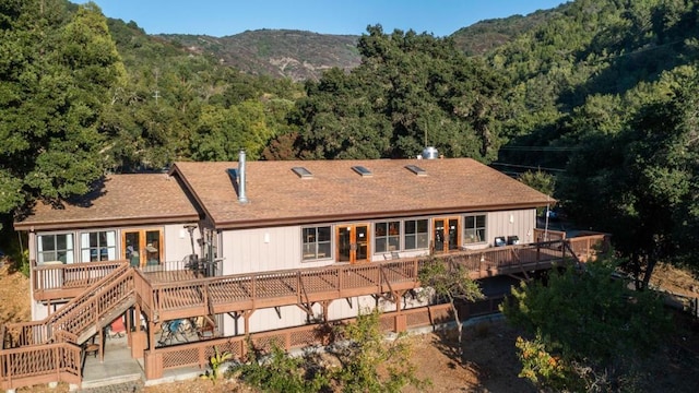 back of property featuring french doors and a deck with mountain view