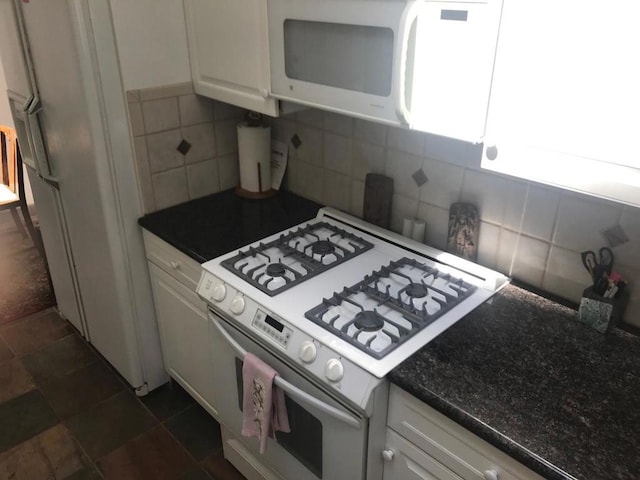 kitchen featuring white appliances, white cabinetry, and decorative backsplash