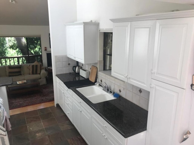 kitchen with sink, white cabinetry, and decorative backsplash