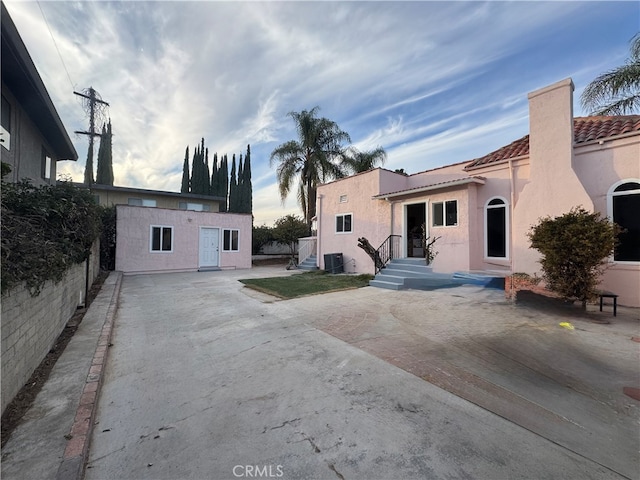 rear view of house with cooling unit