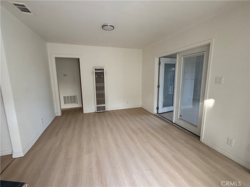 unfurnished room with light wood-type flooring