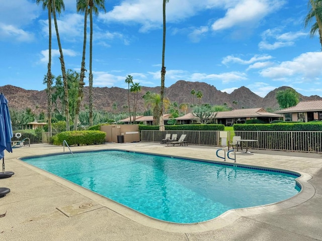 view of pool with a mountain view and a patio area