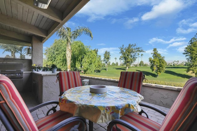 view of patio featuring exterior bar, an outdoor kitchen, and area for grilling