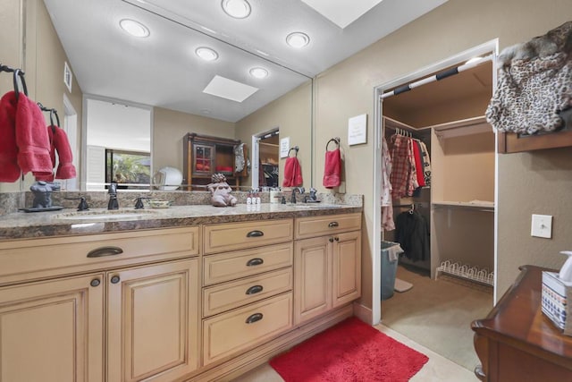 bathroom featuring a skylight and vanity