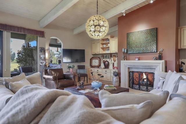 living room with a notable chandelier and beam ceiling