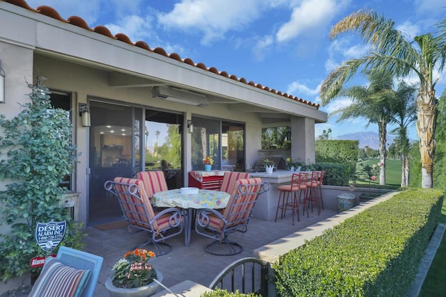 view of patio featuring an outdoor bar