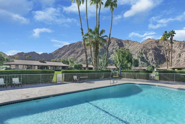 view of swimming pool featuring a mountain view and a patio area