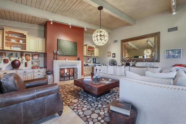 tiled living room with rail lighting and beamed ceiling