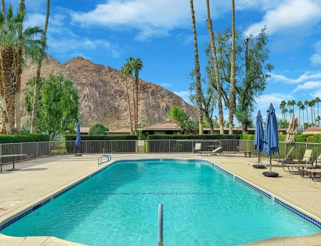 view of pool featuring a mountain view and a patio area