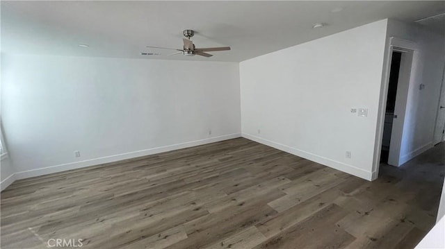 spare room with ceiling fan and dark hardwood / wood-style flooring