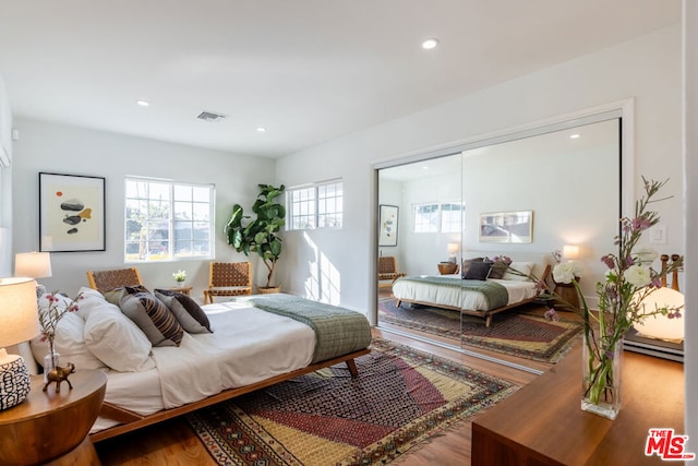 bedroom with wood-type flooring