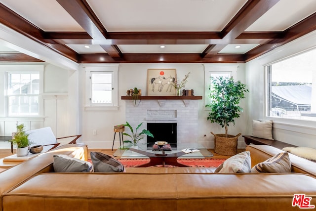 living room with coffered ceiling, beamed ceiling, and a wealth of natural light