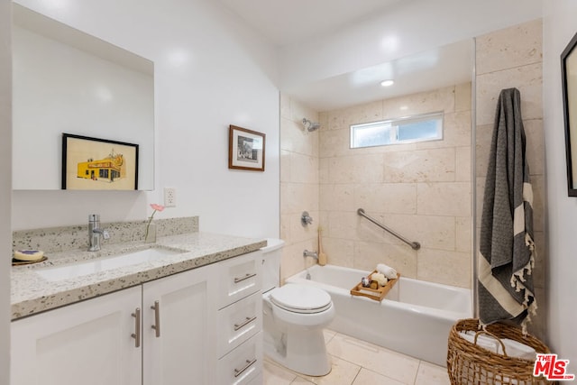 full bathroom with vanity, toilet, tiled shower / bath, and tile patterned floors