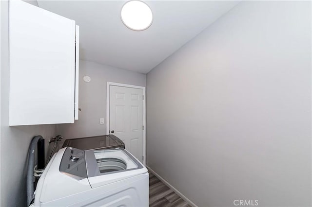 washroom featuring cabinets, dark hardwood / wood-style flooring, and independent washer and dryer