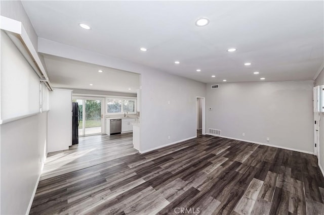 unfurnished living room featuring dark wood-type flooring