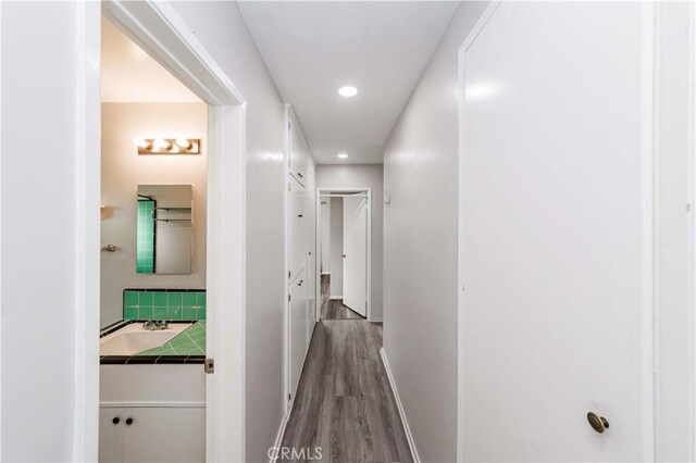 hallway with hardwood / wood-style flooring