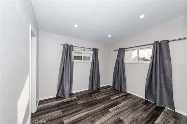 unfurnished room featuring plenty of natural light and dark hardwood / wood-style flooring