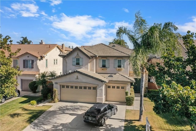 view of front of property with a garage and a front lawn