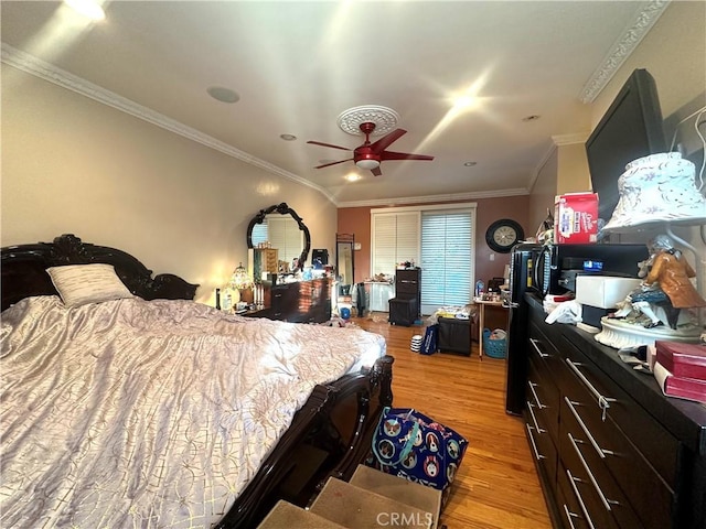 bedroom with light wood-type flooring, ceiling fan, and ornamental molding