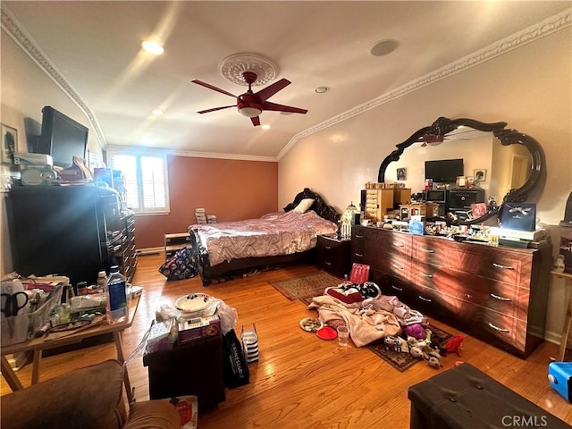 bedroom featuring light wood-type flooring, ceiling fan, and ornamental molding