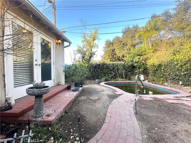 view of patio / terrace with a fenced in pool