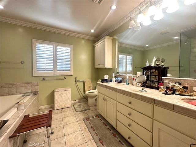 bathroom with crown molding, tile patterned flooring, toilet, vanity, and tiled bath