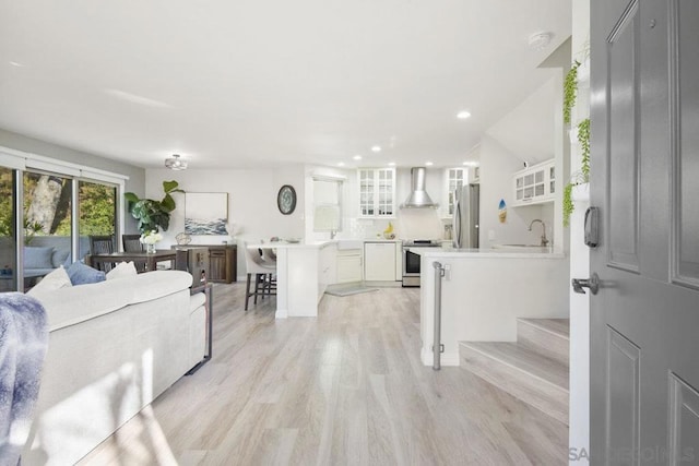 living room featuring sink and light hardwood / wood-style floors