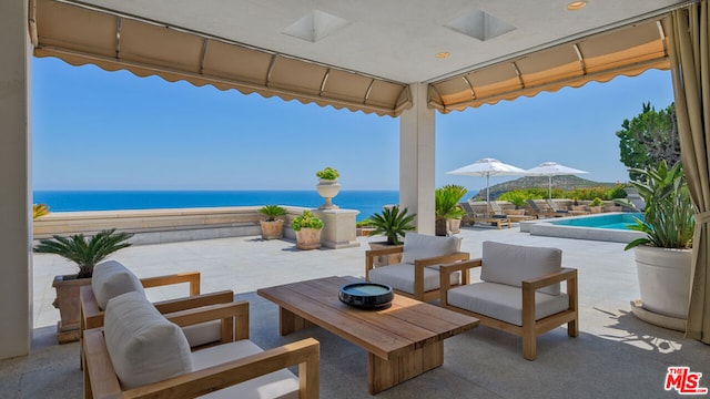 view of patio with an outdoor living space and a water view