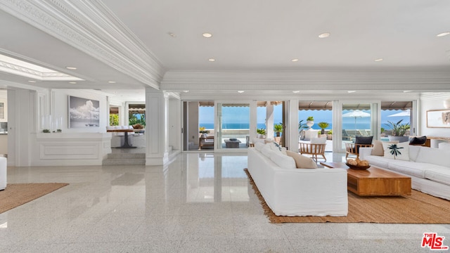 living room featuring crown molding and ornate columns