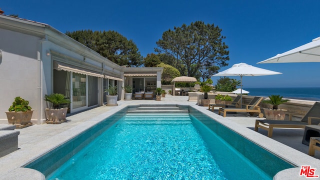 view of swimming pool featuring a water view, an outdoor hangout area, and a patio