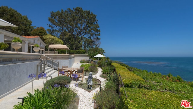 exterior space featuring a patio area and a water view