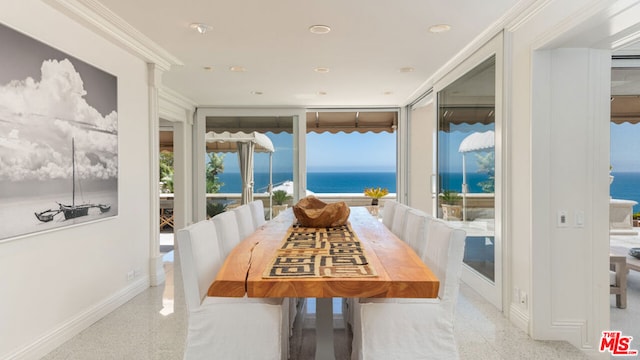 sunroom / solarium with plenty of natural light and a water view