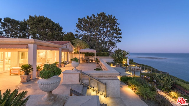 patio terrace at dusk with a water view