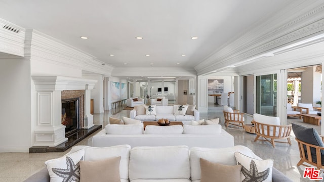 living room with ornamental molding, decorative columns, french doors, and a premium fireplace