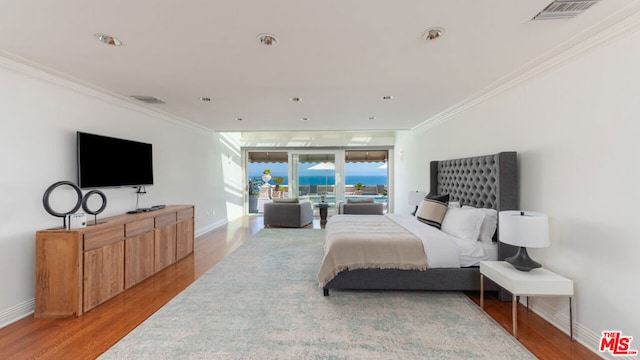 bedroom featuring crown molding and light hardwood / wood-style floors