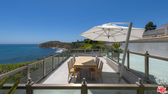 view of patio with a balcony and a water view