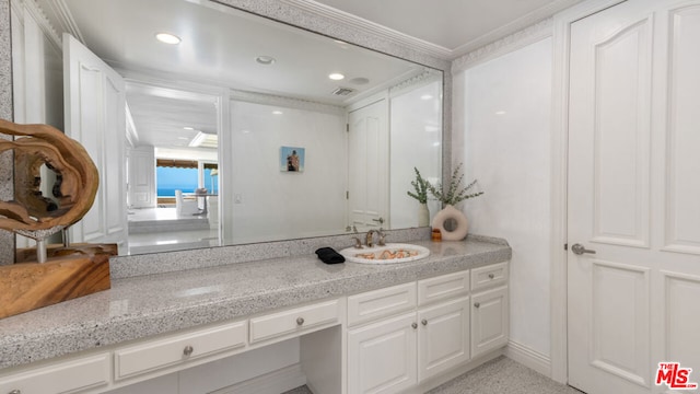 bathroom with vanity and ornamental molding