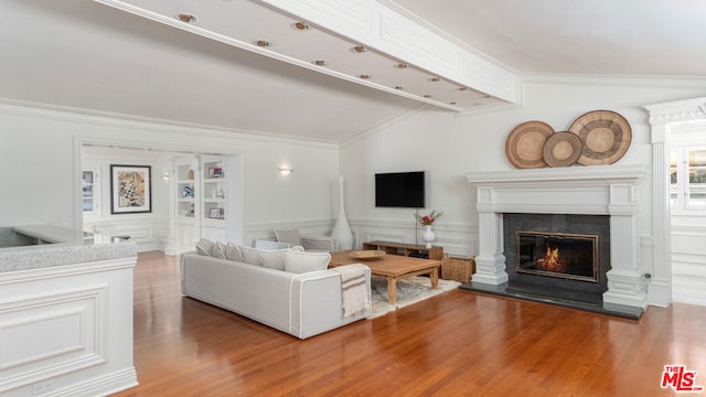 living room featuring hardwood / wood-style floors and crown molding