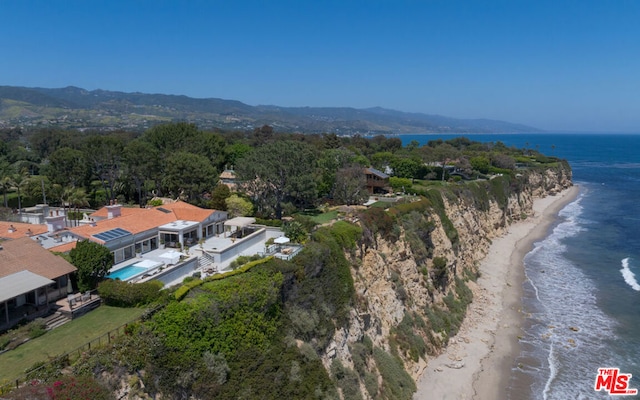 bird's eye view with a water view and a beach view