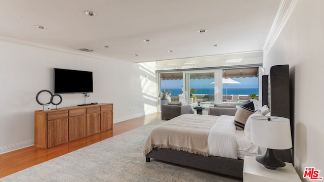 bedroom with light hardwood / wood-style flooring and crown molding